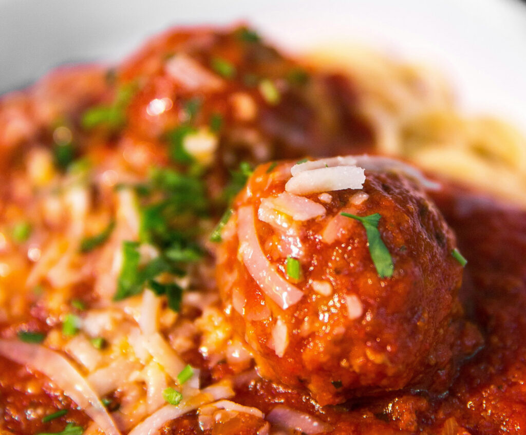 Close up of tomato sauce and meatball