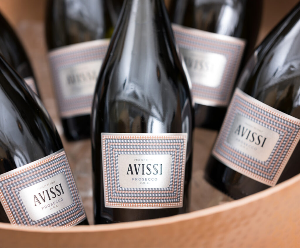 A bowl of ice with bottles of Avissi Prosecco